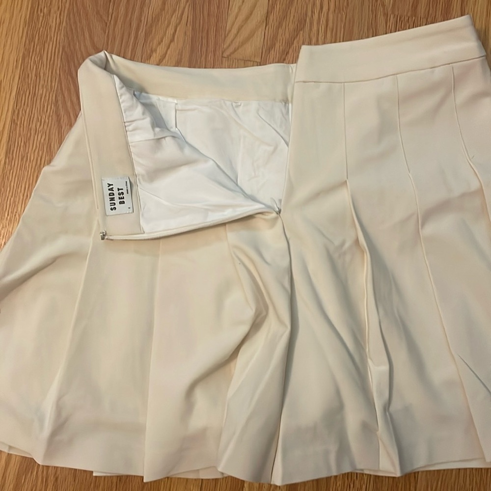 Short ivory pleated skirt originally purchased at Aritzia. Worn once.